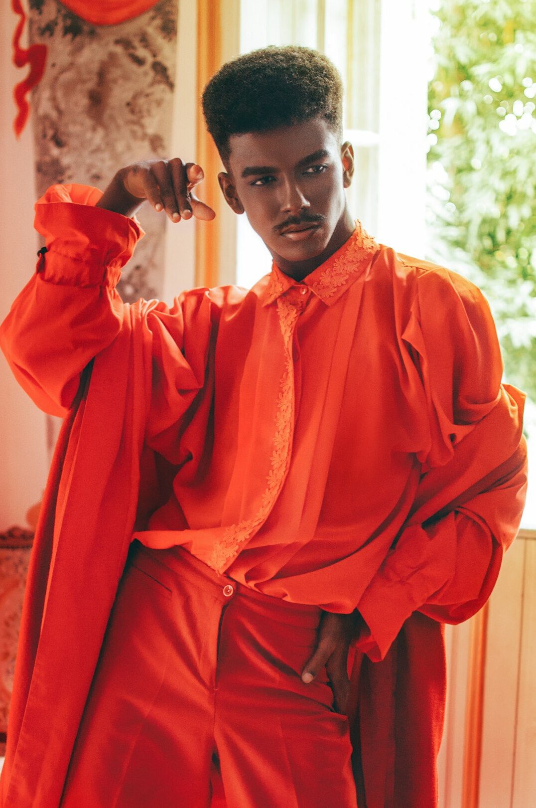 Studio portrait of a Black Brazilian man in a collared shirt