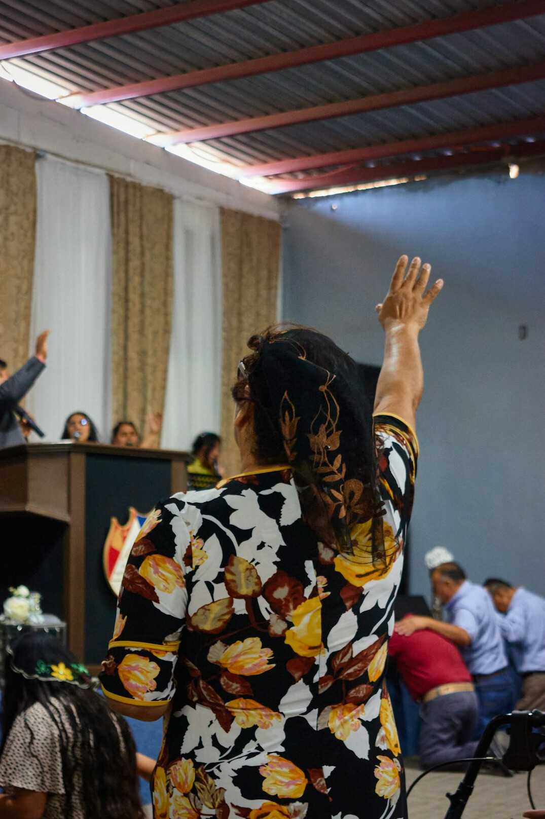 Brazilian woman practicing public speaking in front of a small group