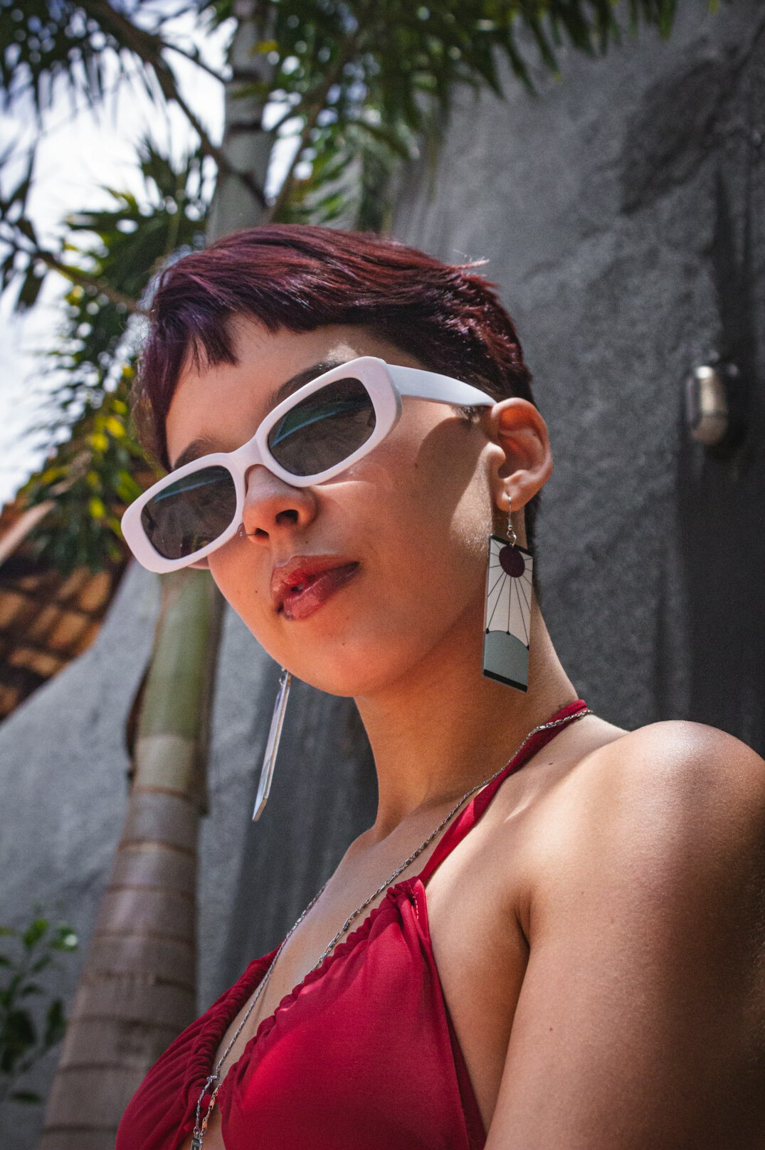 Studio portrait of a Brazilian woman with short hair and glasses