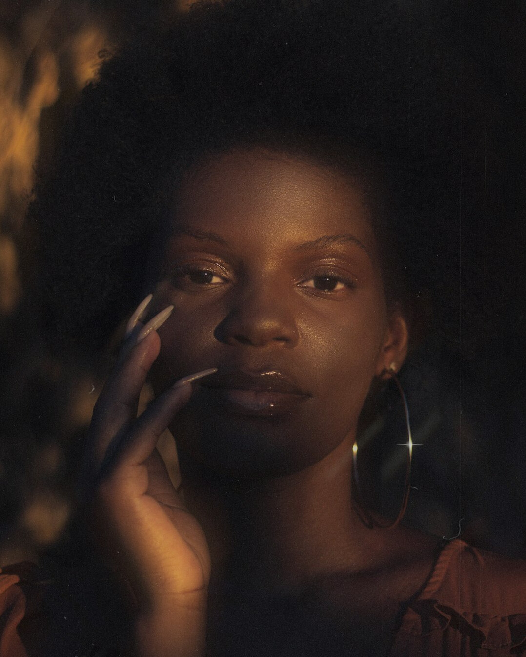 Studio portrait of a young Black Brazilian woman with braids